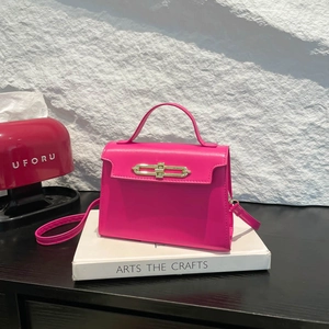 Chic fuchsia faux leather tote bag with gold twist lock and adjustable shoulder strap