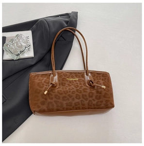 Detail of leopard print tote bag featuring FASHION & BAGS gold text and smooth leather strap