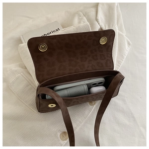 Internal view of brown leopard baguette bag showing capacity for phone and wallet