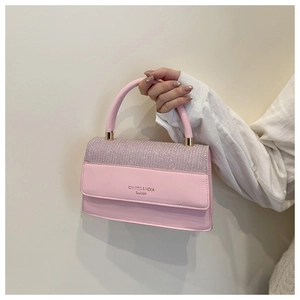 Detail of pink fashion handbag with sparkling rhinestones and premium leather texture