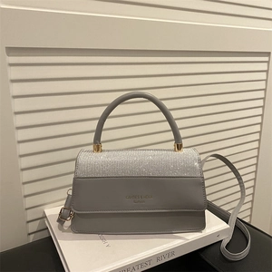 Elegant grey leather square handbag with glitter flap and gold hardware on book