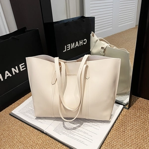 Minimalist cream faux leather tote bag with long handles and fashion text print