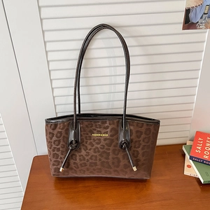 Leopard print faux fur tote bag with brown leather straps and gold fashion lettering