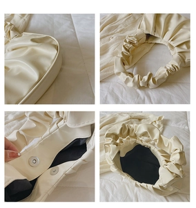 Detailansicht der beigen gerafften Cloud-Handtasche mit Magnetverschluss und weicher PU-Struktur