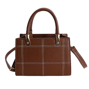 Brown vintage faux leather crossbody handbag with white grid stitching and gold hardware