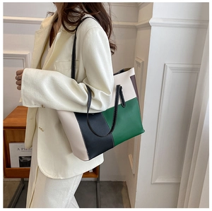 Detail of color-block tote bag with slim shoulder straps and high-capacity structure