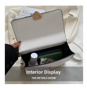 Interior view of white PU leather bag showing spacious storage with golden heart buckle
