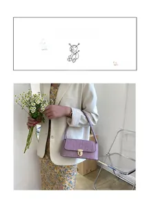Detail of purple crocodile pattern shoulder bag with a gold metal lock buckle