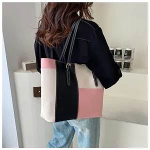 Detailed view of large tote bag with three-color stitching and adjustable shoulder strap