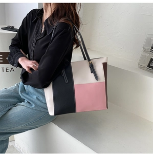 Close-up of contrast color tote bag showing adjustable metal buckle and PU leather texture