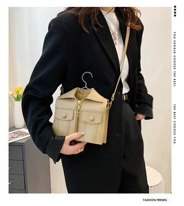 Detail of beige jacket-style mini crossbody bag with zipper and pocket features