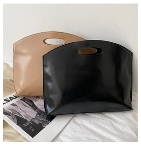 Minimalist tote bags in black and khaki colors with unique cutout circular handles