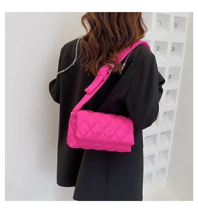 Détail du sac bandoulière rose fuchsia en nylon matelassé avec surpiqûres losanges