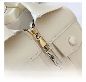 Detail of off-white PU leather jacket collar with premium gold zipper and fine stitching