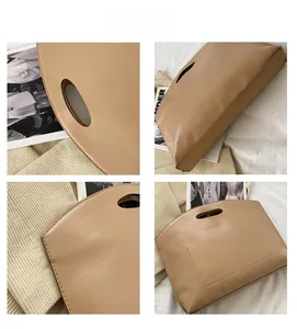 Detail view of khaki minimalist handbag showing fine stitching and matte leather texture