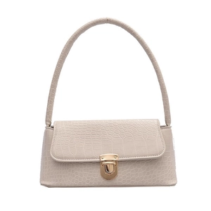 Beige faux leather baguette bag with crocodile texture and gold metal buckle on white background