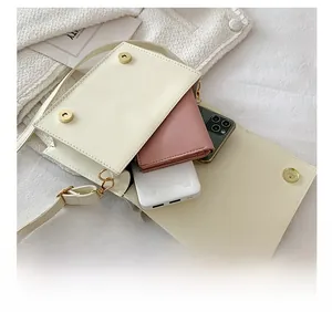 Detailed interior of minimalist off-white flap bag showing phone and wallet storage