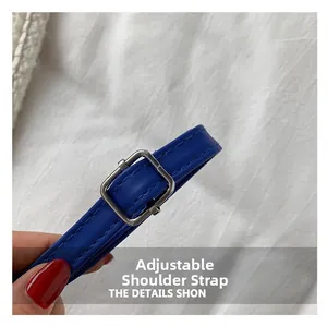 Detail of adjustable blue leather shoulder strap with silver square metal buckle