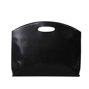 Minimalist black leather briefcase featuring a sleek oval cutout handle and large capacity