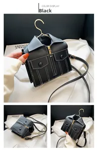 Detailed view of the black motorcycle jacket handbag featuring golden zippers and pocket accents
