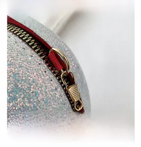 Macro shot of gold metal zipper and shimmering glitter sequins on heart shaped bag