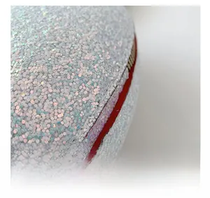 Detailed close-up of holographic sequins and red zipper closure on heart shaped bag