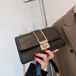 Chic black crocodile embossed leather crossbody bag with gold chain and metal lock