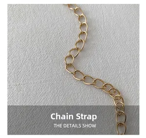 Close-up of elegant gold metal chain shoulder strap for heart-shaped crossbody bag