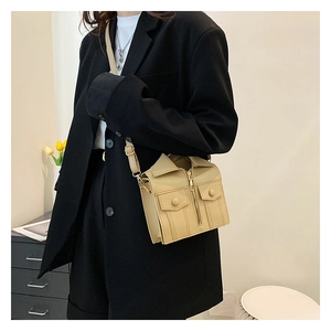 Close-up of jacket-shaped shoulder bag featuring zipper details and beige matte leather