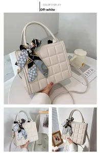 Vue détaillée du sac matelassé crème avec poignée en foulard de soie et texture cuir