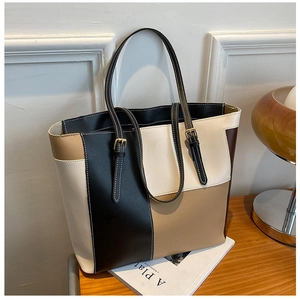 Detail of contrast color tote bag with adjustable shoulder strap and premium PU leather