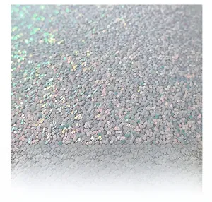 Macro shot of iridescent sequin fabric with silver to purple metallic shimmer detail