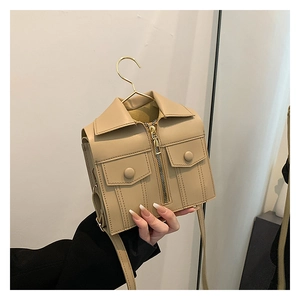 Detail of creative beige jacket-shaped crossbody bag featuring realistic collar and zipper