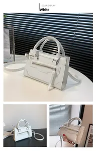 Detailed views of a white structured handbag with decorative tassels and crossbody strap