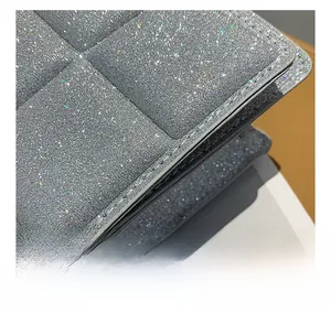 Macro shot of silver sequin glitter fabric with luxury quilted diamond pattern detail