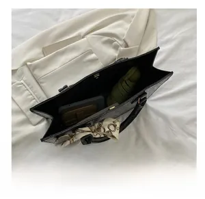 Interior view of large black crocodile pattern tote bag showing high capacity storage