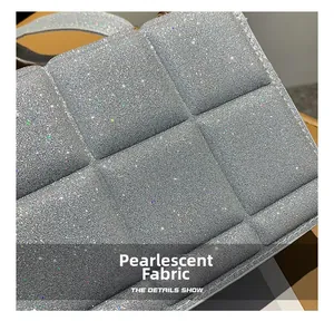 Macro shot of silver quilted bag showing pearlescent glitter texture and detailed stitching