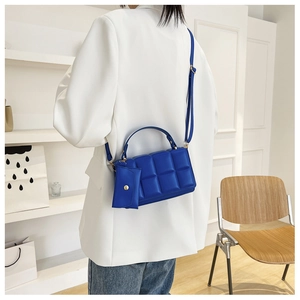 Blue quilted crossbody bag with matching mini coin purse and adjustable strap details