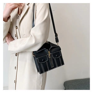 Detail of creative jacket-shaped crossbody bag with zipper and stitching accents
