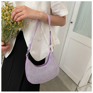 Detail of purple hobo bag with sparkling silver rhinestones and metal chain strap