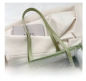 Close-up of mint green transparent PVC tote with leather handles and inner pouch