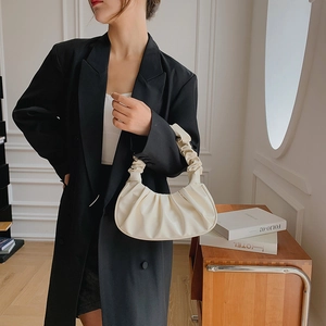 Minimalistische cremeweiße Wolkentasche mit Falten, kombiniert mit schwarzem Blazer