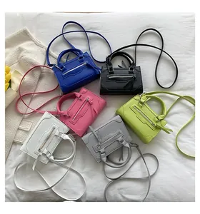 Micro mini crossbody bags in various colors with double handles and zipper detail