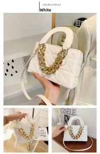 Detailed view of white quilted faux leather bag featuring a chunky gold chain handle
