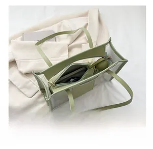 Detail view of large capacity transparent tote bag showing inner pockets with umbrella and phone