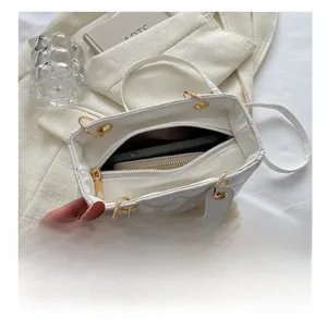 Detailed internal view showing capacity of the white quilted crossbody bag for daily items