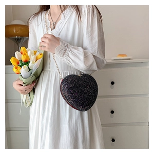 Sparkly black heart-shaped sequin shoulder bag with elegant gold chain strap detail