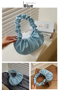 Detail shots of light blue pleated dumpling bag shown in various lifestyle settings