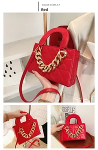 Close-up of red quilted handbag with golden chain strap and refined stitching details