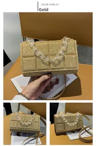 Detail of gold sequin crossbody bag with thick acrylic chain and quilted texture